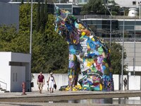 People are seen performing outdoor activities in the surroundings of the Tejo river promenade in Oriente. Lisbon, August 23, 2022. The manda...