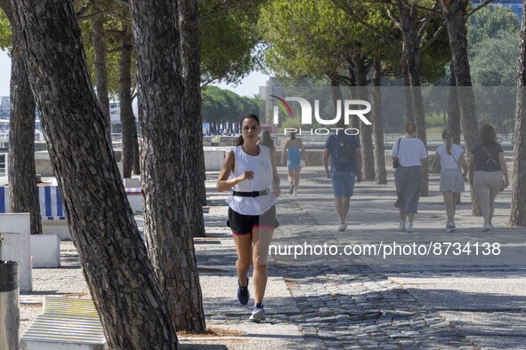 People are seen performing outdoor activities in the surroundings of the Tejo river promenade in Oriente. Lisbon, August 23, 2022. The manda...