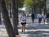 People are seen performing outdoor activities in the surroundings of the Tejo river promenade in Oriente. Lisbon, August 23, 2022. The manda...