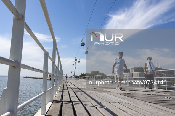 People are seen performing outdoor activities in the surroundings of the Tejo river promenade in Oriente. Lisbon, August 23, 2022. The manda...