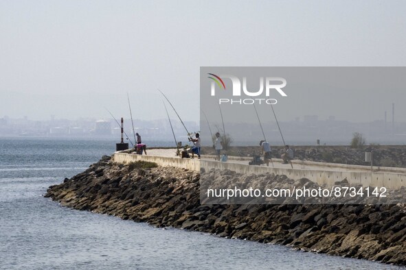 People are seen performing outdoor activities in the surroundings of the Tejo river promenade in Oriente. Lisbon, August 23, 2022. The manda...