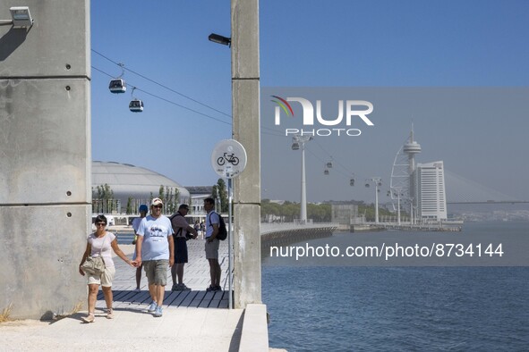 People are seen performing outdoor activities in the surroundings of the Tejo river promenade in Oriente. Lisbon, August 23, 2022. The manda...