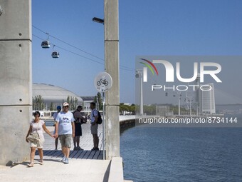 People are seen performing outdoor activities in the surroundings of the Tejo river promenade in Oriente. Lisbon, August 23, 2022. The manda...