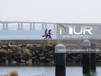 People are seen performing outdoor activities in the surroundings of the Tejo river promenade in Oriente. Lisbon, August 23, 2022. The manda...