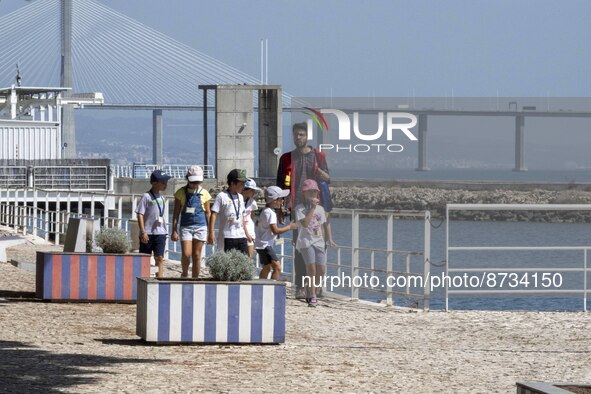 People are seen performing outdoor activities in the surroundings of the Tejo river promenade in Oriente. Lisbon, August 23, 2022. The manda...