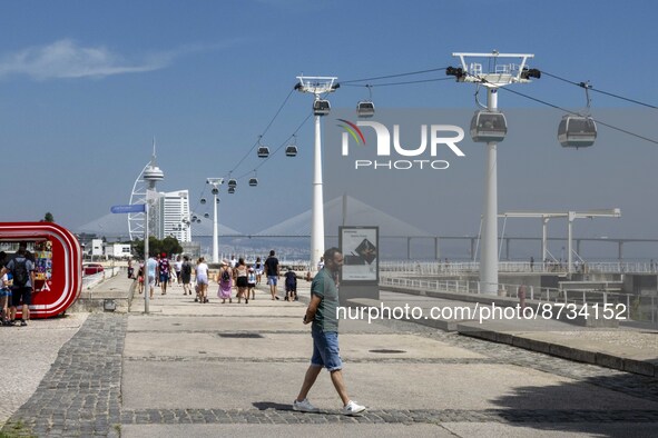 People are seen performing outdoor activities in the surroundings of the Tejo river promenade in Oriente. Lisbon, August 23, 2022. The manda...