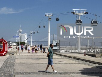 People are seen performing outdoor activities in the surroundings of the Tejo river promenade in Oriente. Lisbon, August 23, 2022. The manda...