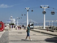 People are seen performing outdoor activities in the surroundings of the Tejo river promenade in Oriente. Lisbon, August 23, 2022. The manda...