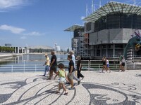 People are seen performing outdoor activities in the surroundings of the Tejo river promenade in Oriente. Lisbon, August 23, 2022. The manda...