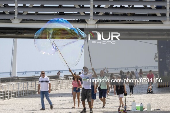 People are seen performing outdoor activities in the surroundings of the Tejo river promenade in Oriente. Lisbon, August 23, 2022. The manda...