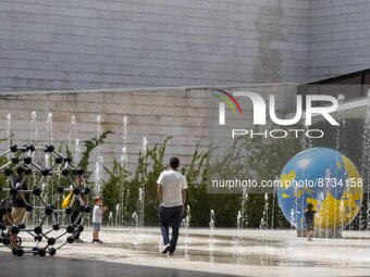 People are seen performing outdoor activities in the surroundings of the Tejo river promenade in Oriente. Lisbon, August 23, 2022. The manda...