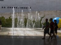 People are seen performing outdoor activities in the surroundings of the Tejo river promenade in Oriente. Lisbon, August 23, 2022. The manda...