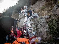 A young boy wraps himself in a termal blanket, in Lesbos, Greece, on September 29, 2015. More than 700,000 refugees and migrants have reache...