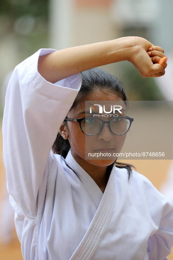 A Student practices martial arts on the playground of a school in Dhaka, Bangladesh on August 30, 2022.  