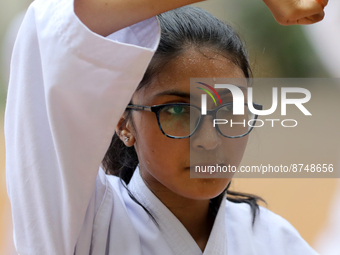 A Student practices martial arts on the playground of a school in Dhaka, Bangladesh on August 30, 2022.  (