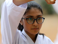 A Student practices martial arts on the playground of a school in Dhaka, Bangladesh on August 30, 2022.  (