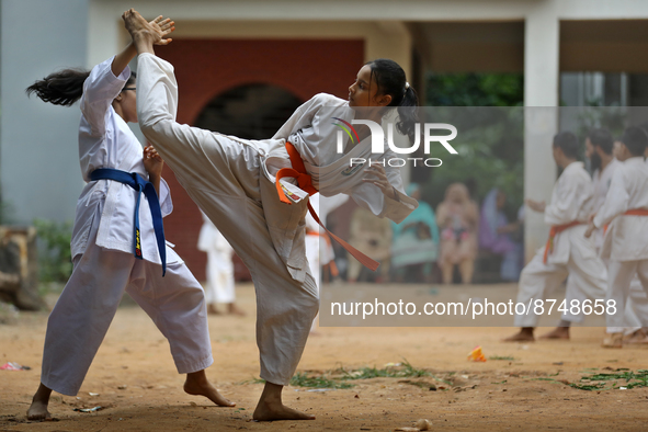 Students practice martial arts on the playground of a school in Dhaka, Bangladesh on August 30, 2022.  