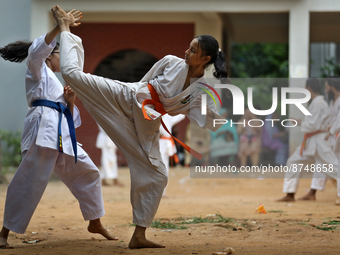 Students practice martial arts on the playground of a school in Dhaka, Bangladesh on August 30, 2022.  (