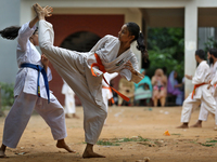 Students practice martial arts on the playground of a school in Dhaka, Bangladesh on August 30, 2022.  (