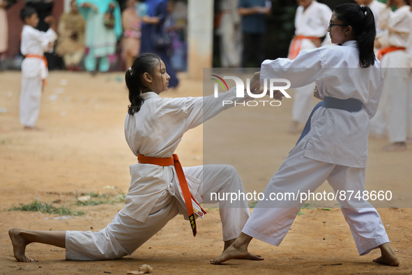 Students practice martial arts on the playground of a school in Dhaka, Bangladesh on August 30, 2022.  