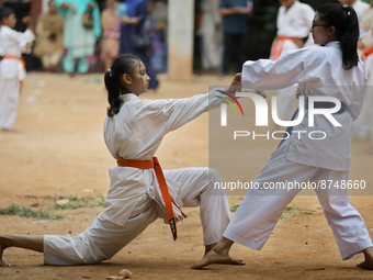 Students practice martial arts on the playground of a school in Dhaka, Bangladesh on August 30, 2022.  (