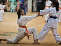 Students practice martial arts on the playground of a school in Dhaka, Bangladesh on August 30, 2022.  (