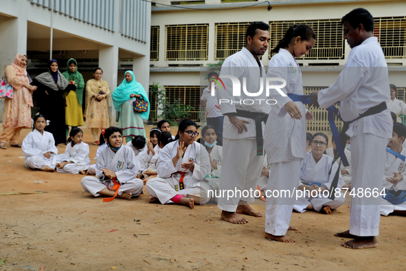 A Student receives a yellow belt during a martial arts class on the playground of a school in Dhaka, Bangladesh on August 30, 2022.  