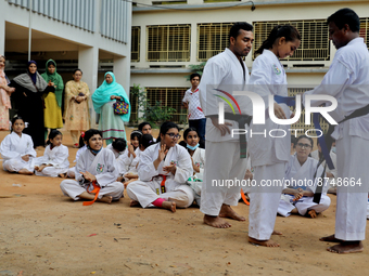 A Student receives a yellow belt during a martial arts class on the playground of a school in Dhaka, Bangladesh on August 30, 2022.  (