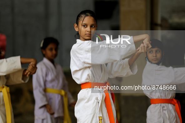 Students practice martial arts on the playground of a school in Dhaka, Bangladesh on August 30, 2022.  