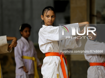 Students practice martial arts on the playground of a school in Dhaka, Bangladesh on August 30, 2022.  (