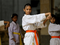 Students practice martial arts on the playground of a school in Dhaka, Bangladesh on August 30, 2022.  (