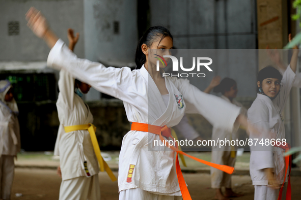 Students practice martial arts on the playground of a school in Dhaka, Bangladesh on August 30, 2022.  