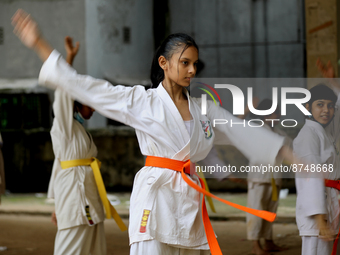 Students practice martial arts on the playground of a school in Dhaka, Bangladesh on August 30, 2022.  (