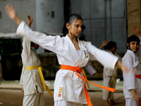 Students practice martial arts on the playground of a school in Dhaka, Bangladesh on August 30, 2022.  (