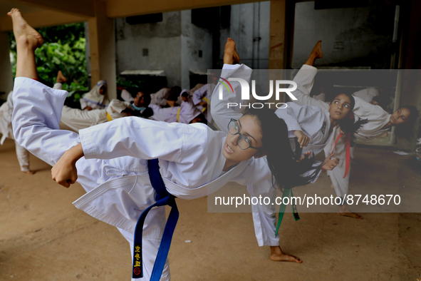 Students practice martial arts on the playground of a school in Dhaka, Bangladesh on August 30, 2022.  