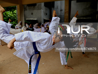 Students practice martial arts on the playground of a school in Dhaka, Bangladesh on August 30, 2022.  (