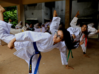 Students practice martial arts on the playground of a school in Dhaka, Bangladesh on August 30, 2022.  (