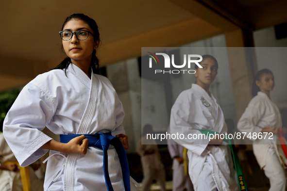 Students practice martial arts on the playground of a school in Dhaka, Bangladesh on August 30, 2022.  