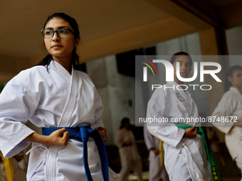 Students practice martial arts on the playground of a school in Dhaka, Bangladesh on August 30, 2022.  (