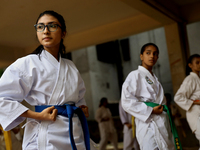 Students practice martial arts on the playground of a school in Dhaka, Bangladesh on August 30, 2022.  (