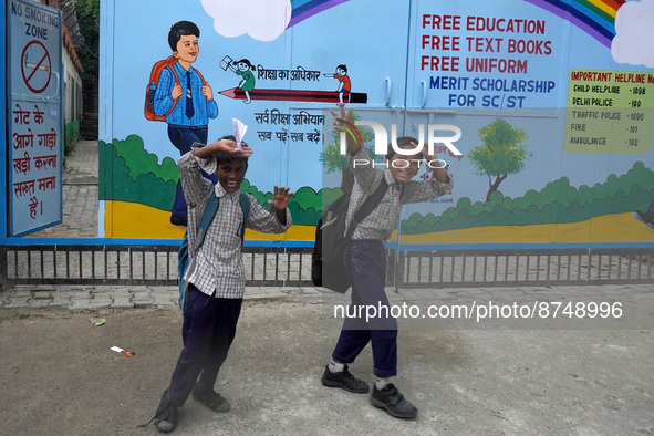 Students react as they go back to their homes after attending school classes in New Delhi on August 30, 2022. 