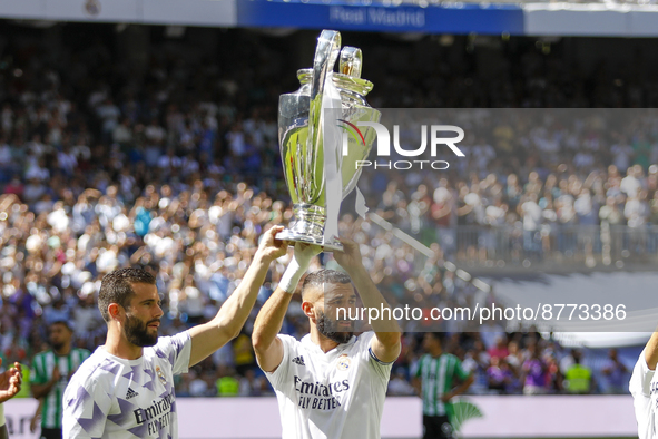 Nacho Fernandez of Real Madrid and Karim Benzema of Real Madrid showing the UEFA Champions League trophiy to their supporters during La Liga...