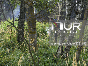 Rescuer extinguishes peat soil fires near the village of Sosnivka in the Kyiv Region, Ukraine September 6, 2022 (