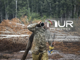 Rescuer extinguishes peat soil fires near the village of Sosnivka in the Kyiv Region, Ukraine September 6, 2022 (