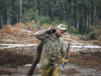 Rescuer extinguishes peat soil fires near the village of Sosnivka in the Kyiv Region, Ukraine September 6, 2022 (