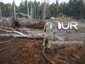 Rescuer extinguishes peat soil fires near the village of Sosnivka in the Kyiv Region, Ukraine September 6, 2022 (