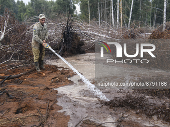 Rescuer extinguishes peat soil fires near the village of Sosnivka in the Kyiv Region, Ukraine September 6, 2022 (