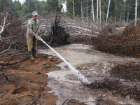 Rescuer extinguishes peat soil fires near the village of Sosnivka in the Kyiv Region, Ukraine September 6, 2022 (