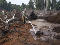 Rescuer extinguishes peat soil fires near the village of Sosnivka in the Kyiv Region, Ukraine September 6, 2022 (