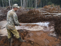 Rescuer extinguishes peat soil fires near the village of Sosnivka in the Kyiv Region, Ukraine September 6, 2022 (